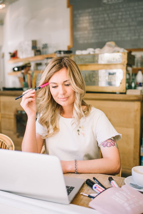 Partner working from a coffee shop on their laptop, earning recurring commissions